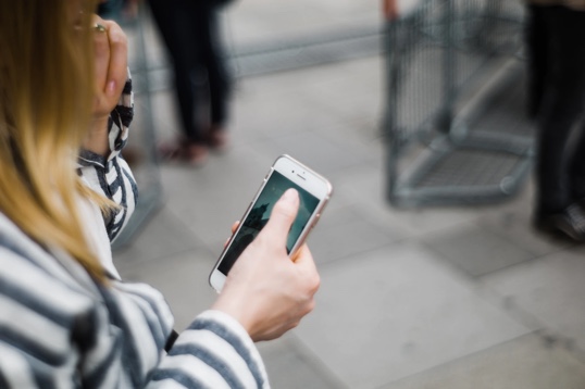 Woman's hand holding a mobile phone